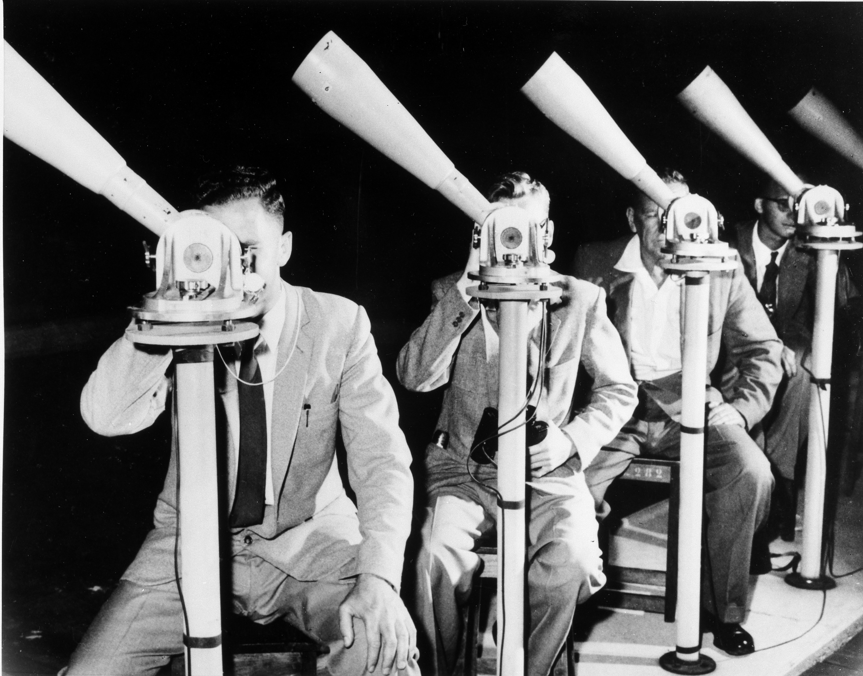 Volunteers look through telescopes for the SAO's Moonwatch Network.