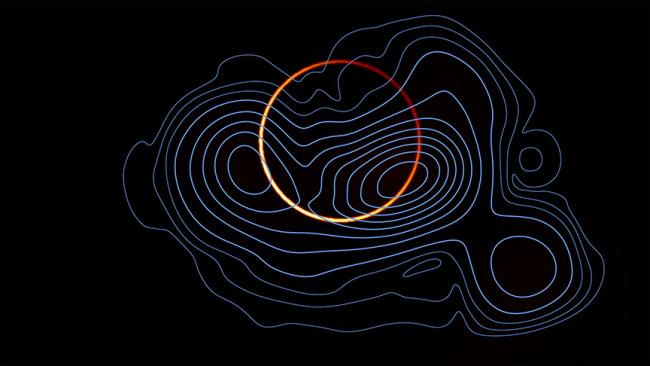 The emission from M87 has now been resolved into a bright, thin ring (orange colormap), arising from the infinite sequence of additional images of the emission region, and the more diffuse primary image, produced by the photons that come directly toward Earth (in blue contours).