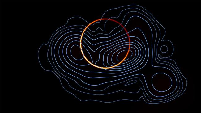 The emission from M87 has now been resolved into a bright, thin ring (orange colormap), arising from the infinite sequence of additional images of the emission region, and the more diffuse primary image, produced by the photons that come directly toward Earth (in blue contours). 